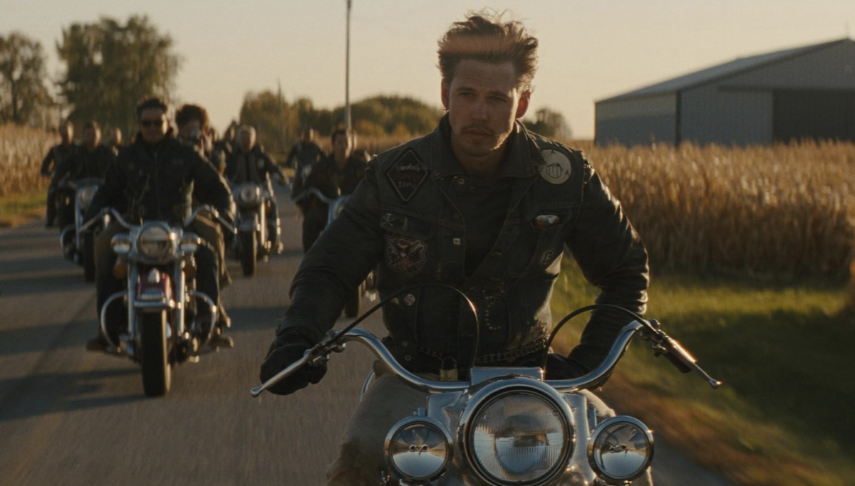 Austin Butler as Benny riding alongside fellow members of The Vandals M.C. within “The Bikeriders Official Trailer 2.”